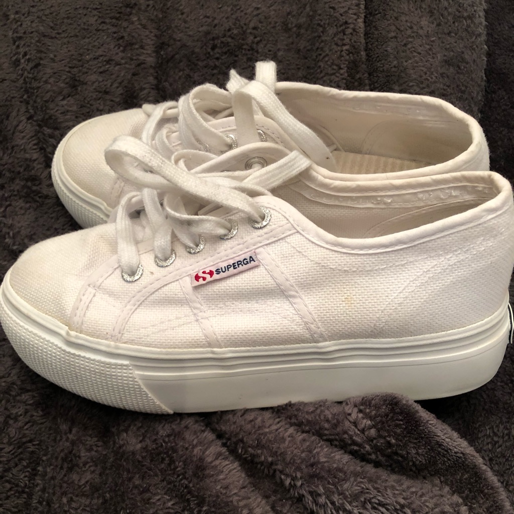 White Superga canvas platform sneakers with a thick white flatform sole, photographed from above